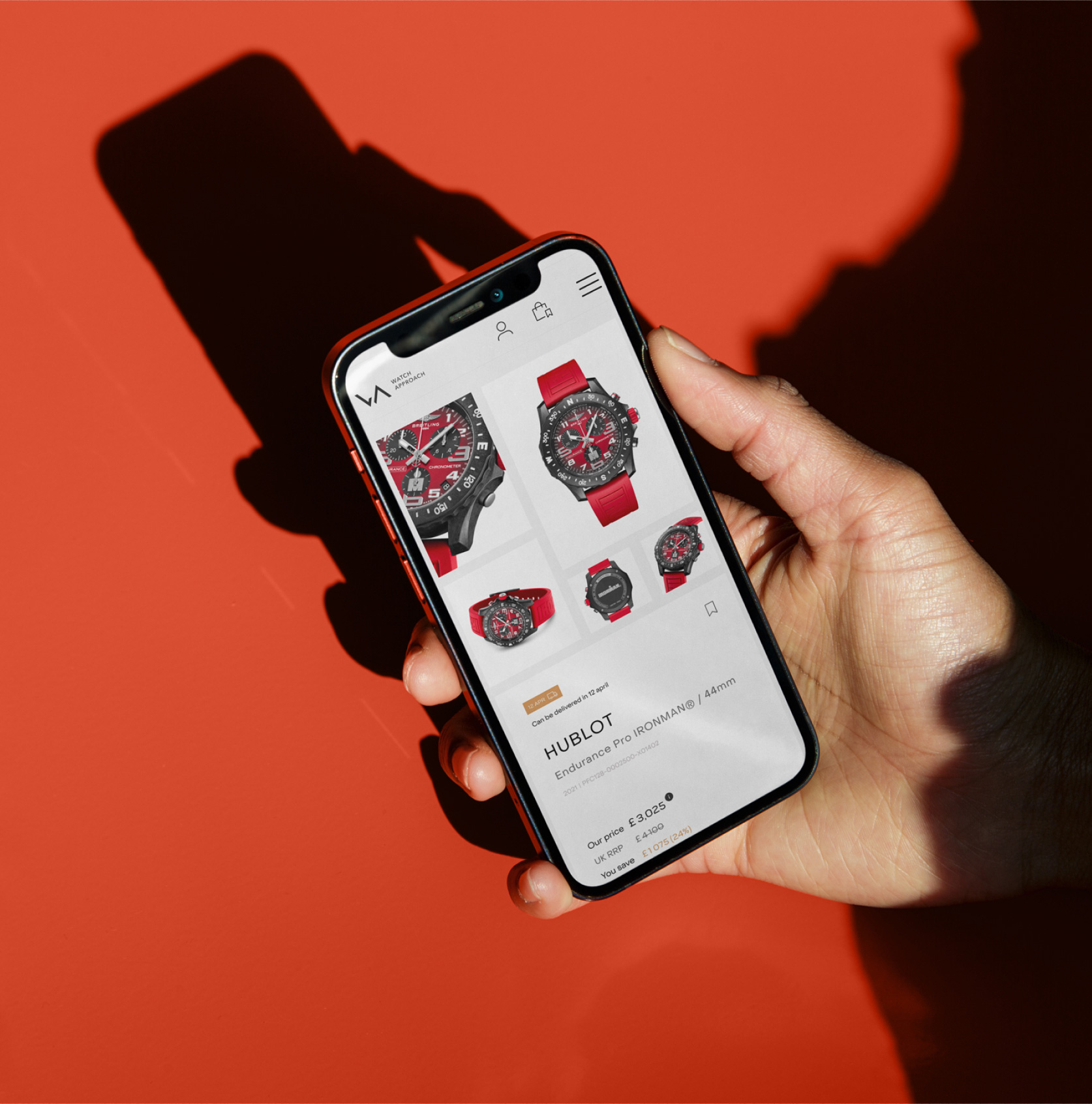 Mobile phone on a red background displaying the Watch approach website new design.